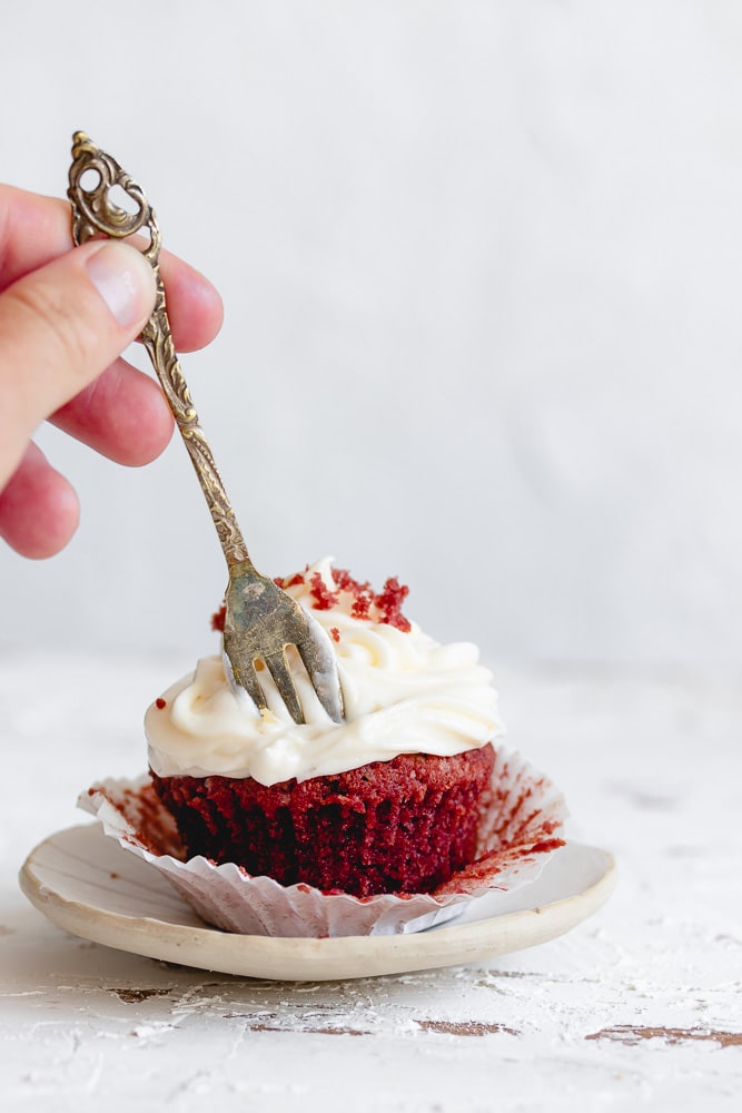Red velvet cupcakes with cream cheese with a fork