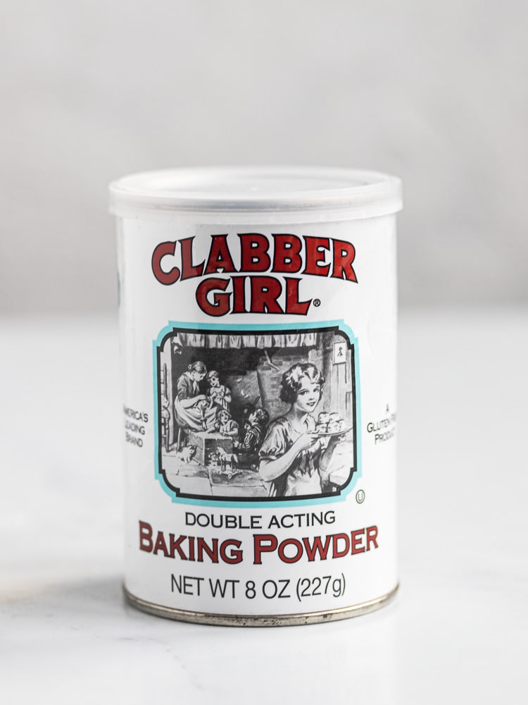Photo of grabber girl baking powder with a white background