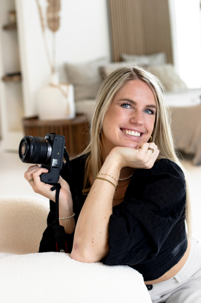 Food photographer Fleur Vrakking (fleurfoodie) holding her camera for a professional brand shoot.